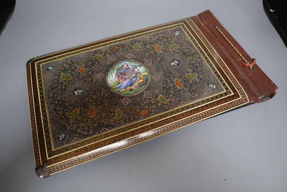 An Iranian photograph album, front and back covers with elaborate mounts, 17 x 10in.